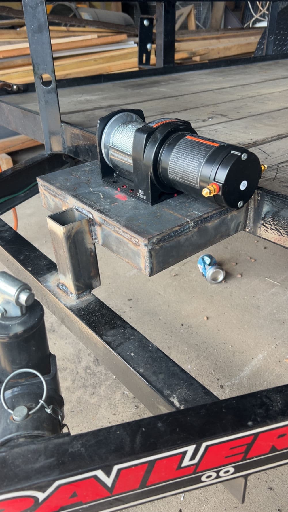 Winch mounted on trailer frame for heavy-duty towing and hauling applications.